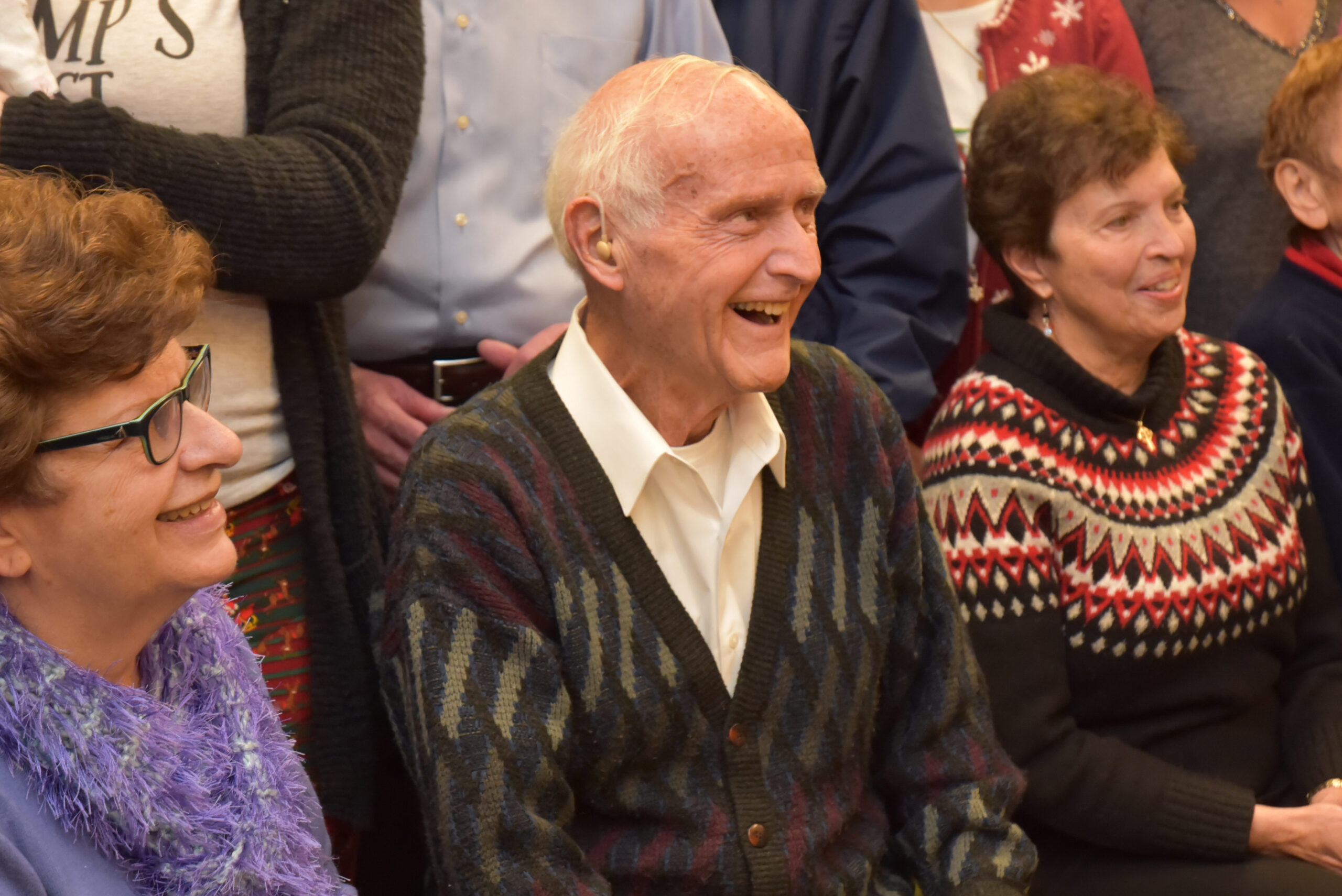 An elderly man seated at an event