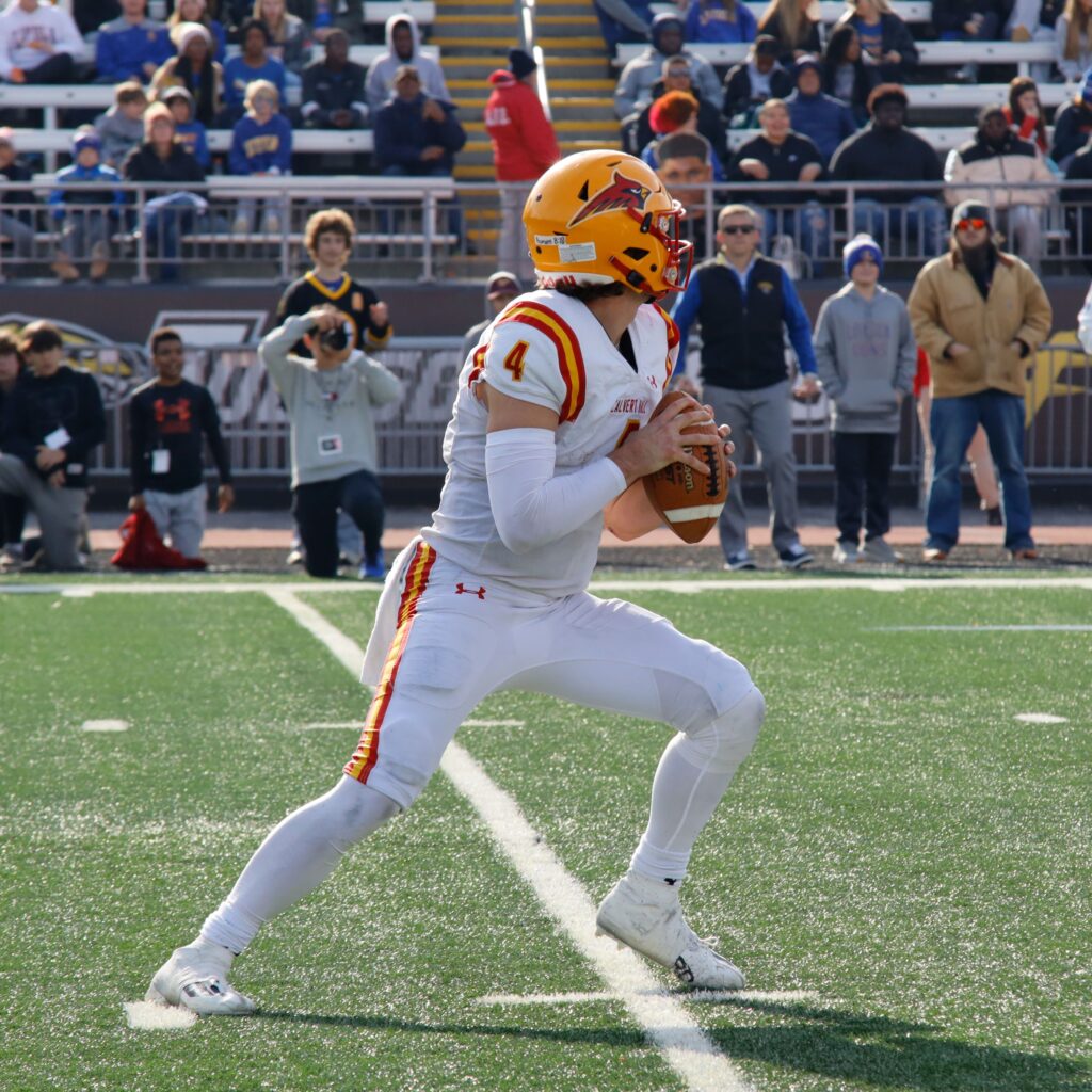 A football quarterback during game play
