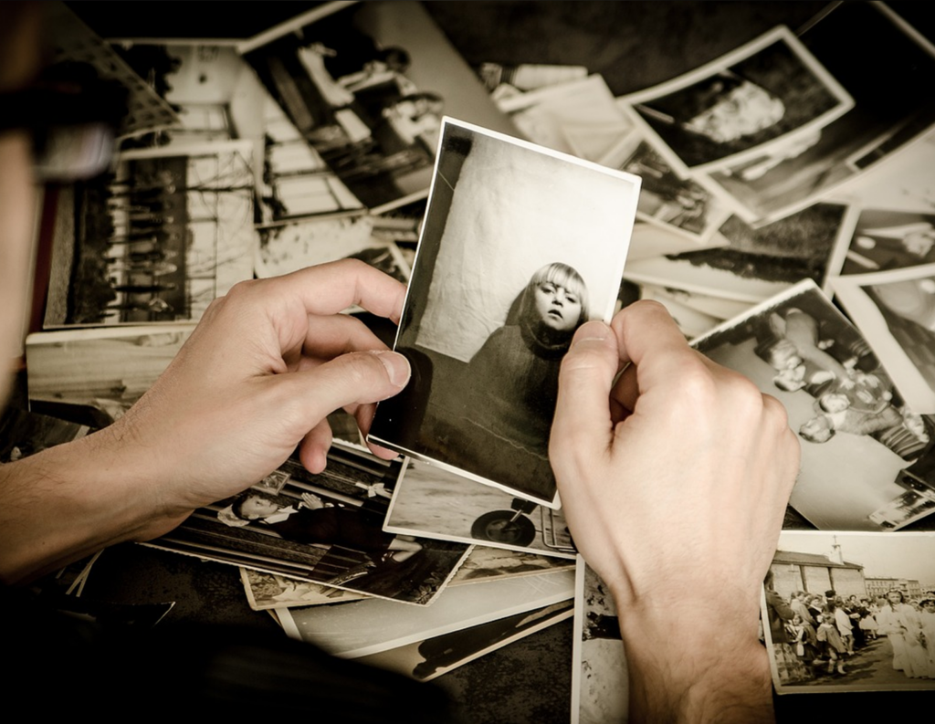 A man holding a sepia photo