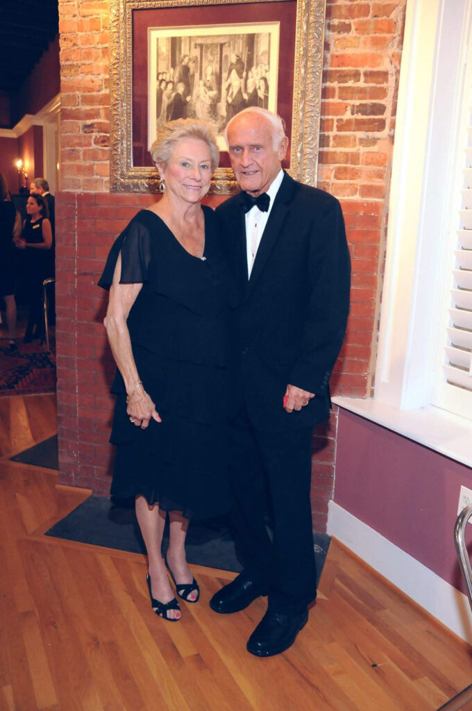 Frank and Elaine Galeone standing in front of a fireplace. 